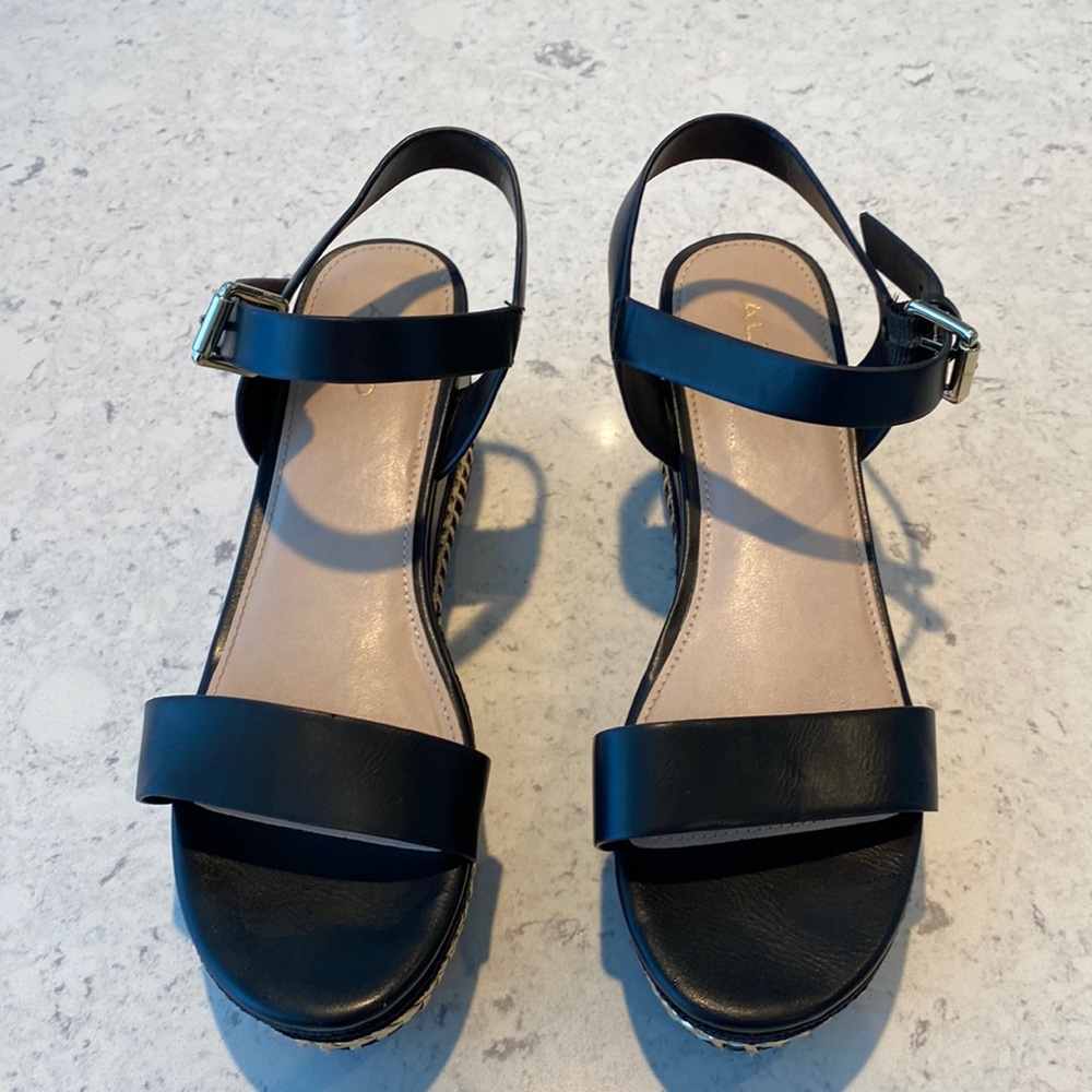 Aldo black platform sandals with gold whip stitch.